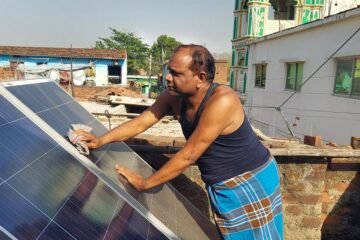 Solar panel cleaning by indian village man