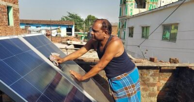 Solar panel cleaning by indian village man